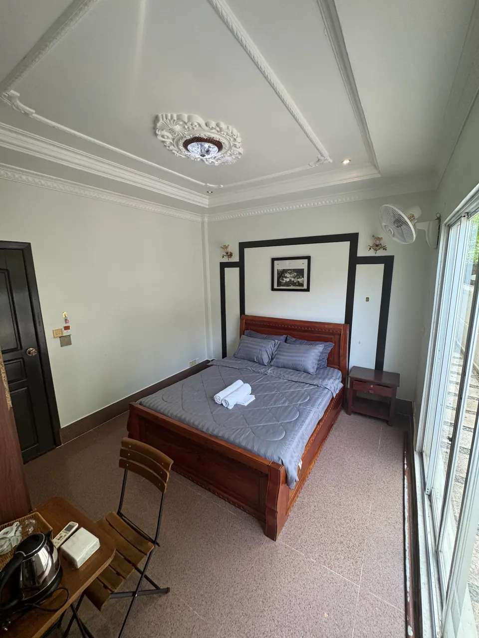 Deluxe king room with a carved wooden bed