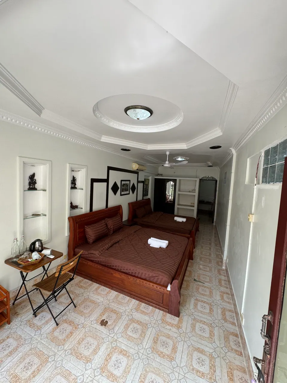 Family room with two double beds and a tea table