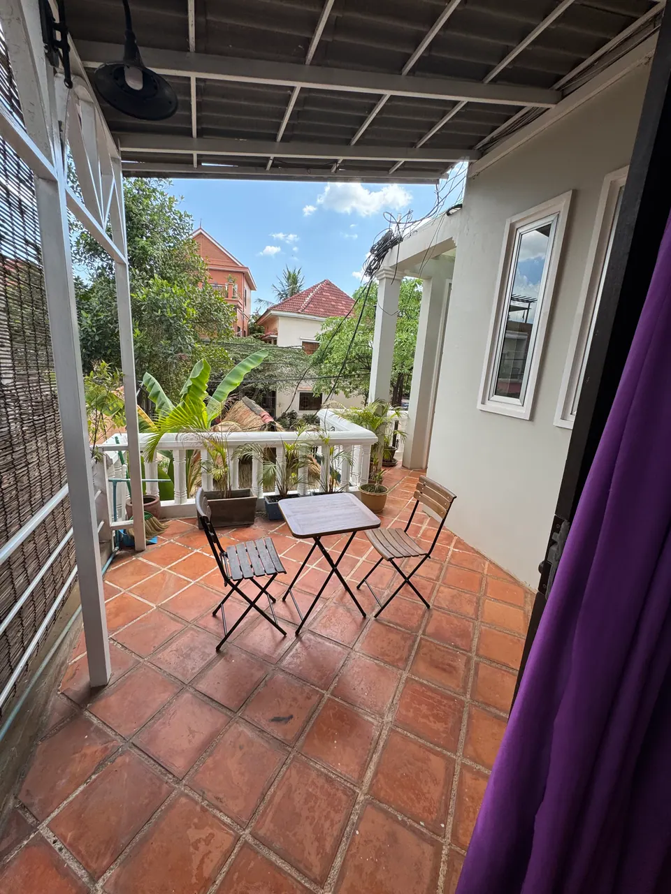 Private terrace with a bistro table among the plants