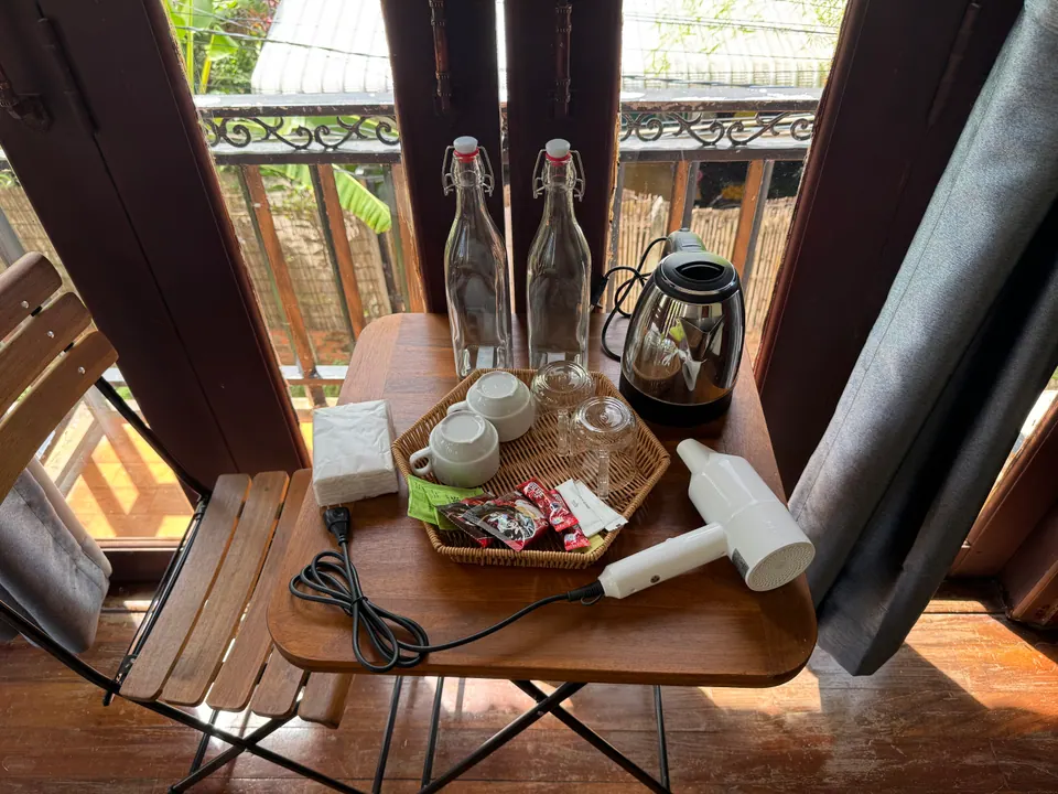 Balcony table with kettle, glass bottles and hair dryer